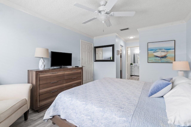 bedroom with light hardwood / wood-style floors, ensuite bath, ceiling fan, and ornamental molding