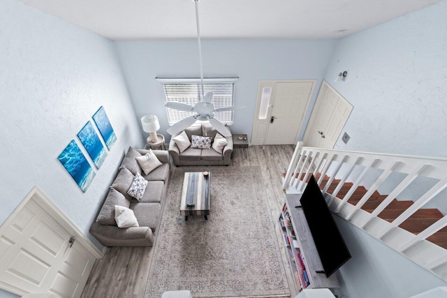 living room featuring hardwood / wood-style floors and ceiling fan