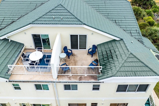 back of property featuring a balcony