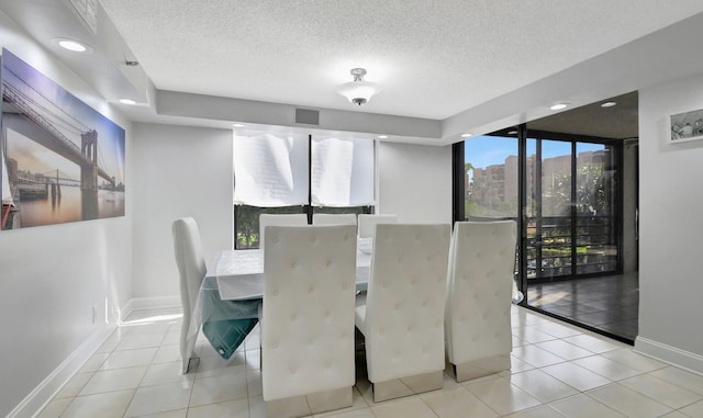 dining room featuring light tile patterned flooring and a textured ceiling