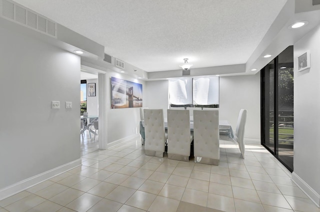 unfurnished dining area with light tile patterned floors and a textured ceiling