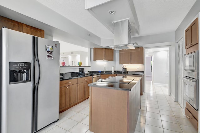 kitchen featuring island exhaust hood, a center island, a textured ceiling, and appliances with stainless steel finishes