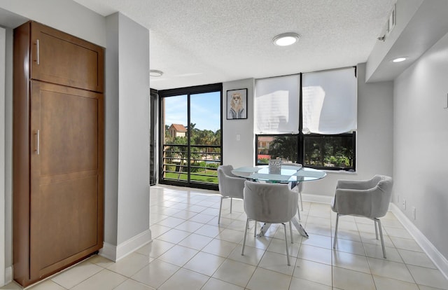 dining room with light tile patterned floors and a textured ceiling