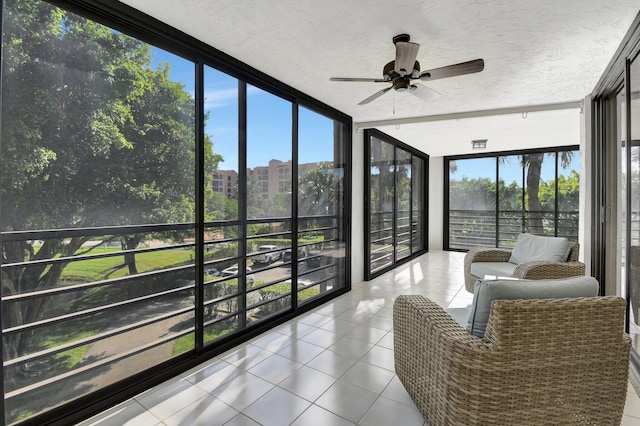 sunroom / solarium featuring ceiling fan