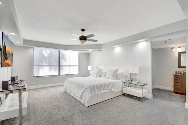 bedroom featuring carpet flooring, ceiling fan, and a textured ceiling