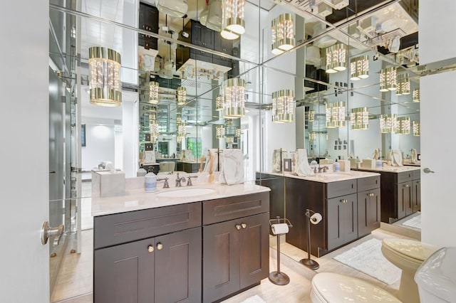 bathroom with hardwood / wood-style floors, vanity, and a towering ceiling