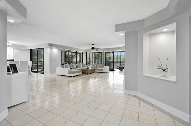 living room with ceiling fan and light tile patterned floors