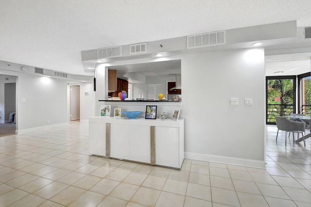 kitchen featuring light tile patterned floors and a textured ceiling