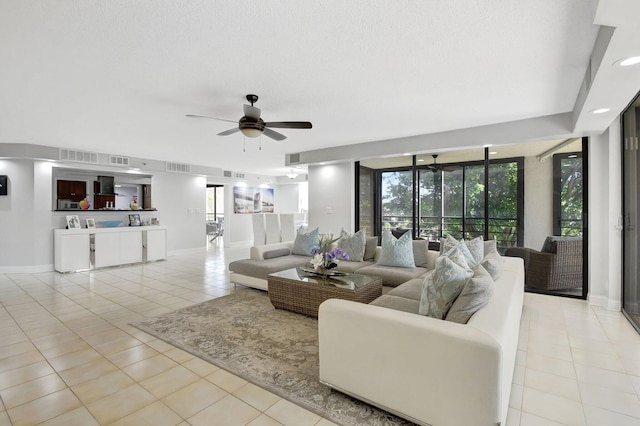 tiled living room featuring ceiling fan and a textured ceiling