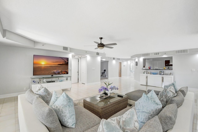 living room featuring ceiling fan and light tile patterned floors