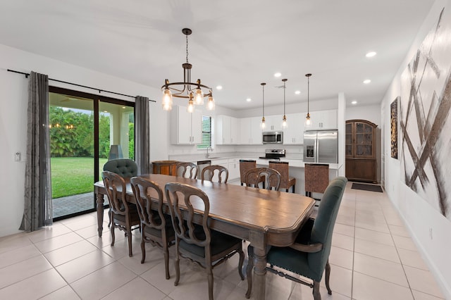 dining space with sink, light tile patterned flooring, and a notable chandelier