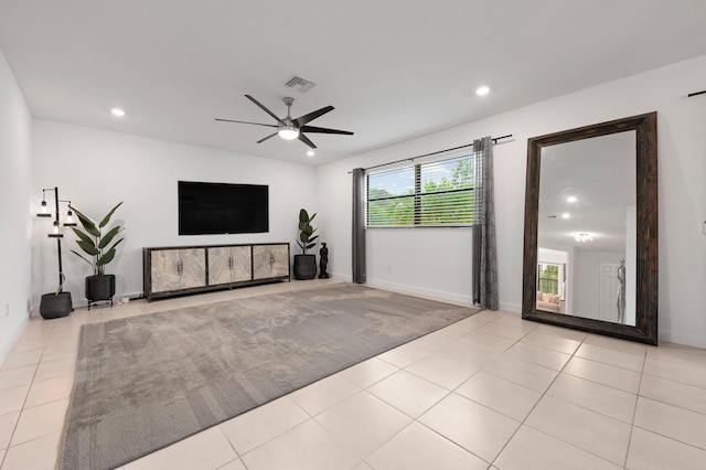 unfurnished living room featuring light tile patterned floors and ceiling fan