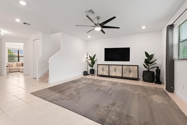 tiled living room with ceiling fan