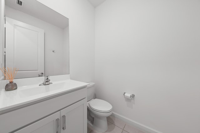 bathroom featuring tile patterned flooring, vanity, and toilet