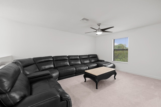 carpeted living room with ceiling fan