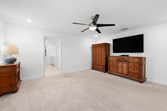 carpeted bedroom featuring ceiling fan and ensuite bath