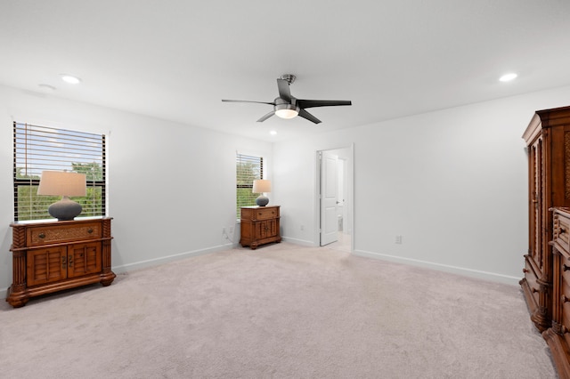 carpeted bedroom with ceiling fan and ensuite bath