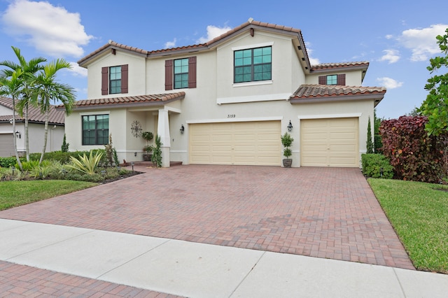 mediterranean / spanish home featuring a garage