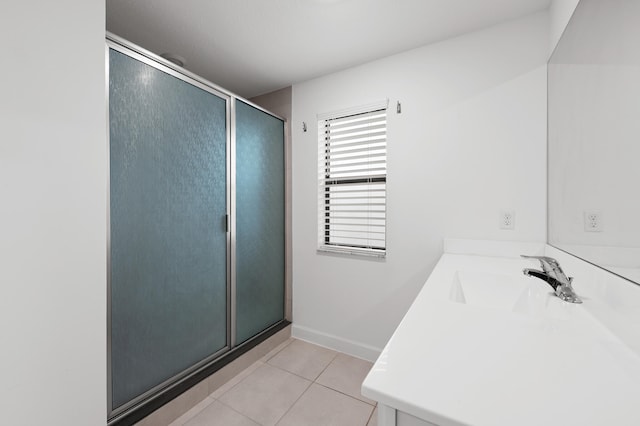 bathroom with tile patterned flooring, vanity, and an enclosed shower