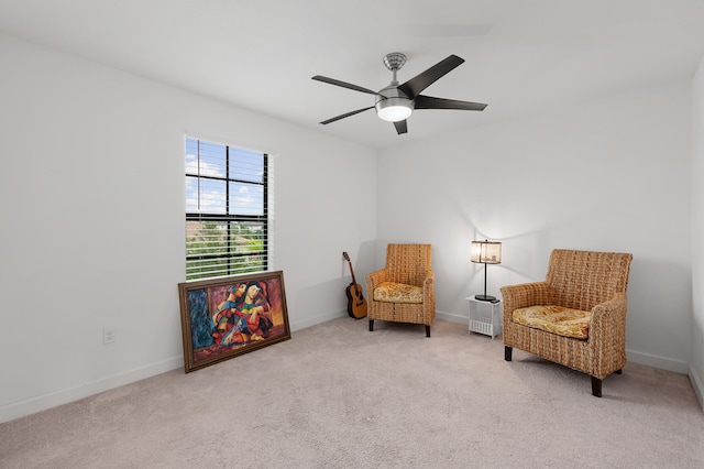 sitting room featuring ceiling fan and light carpet