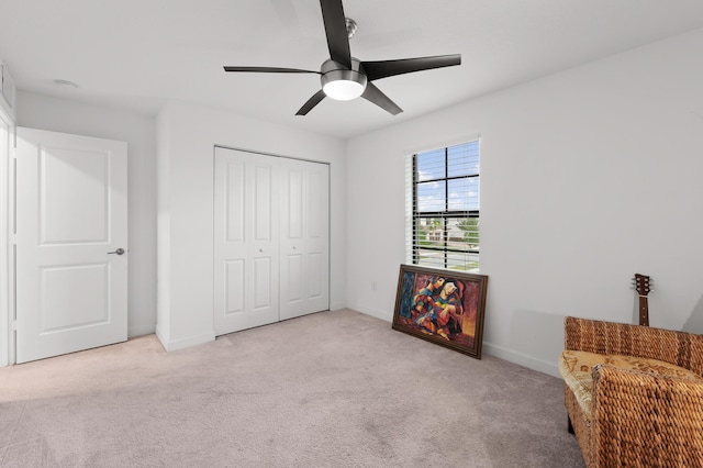 unfurnished room featuring ceiling fan and light colored carpet