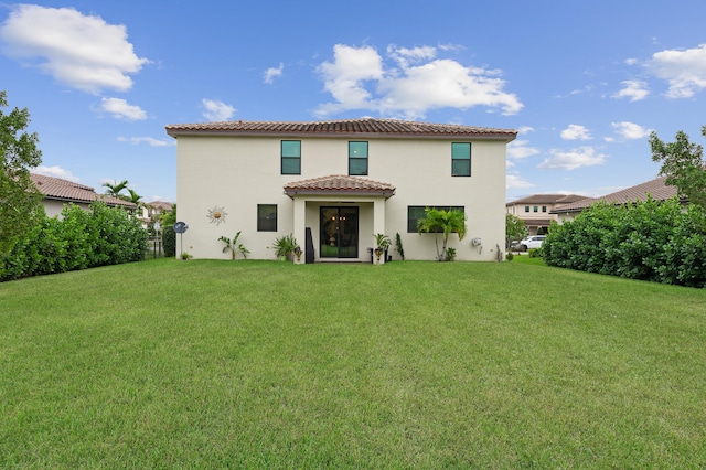 back of house with a lawn