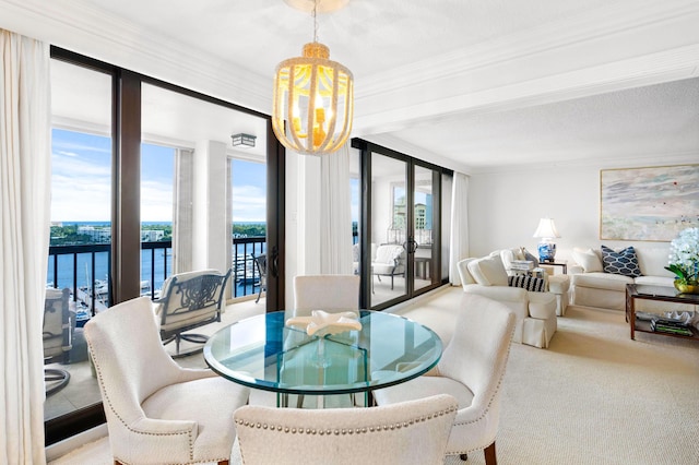 carpeted dining area with a chandelier, a wealth of natural light, crown molding, and expansive windows