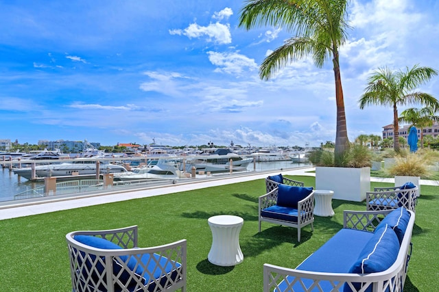 view of yard featuring a water view and a dock