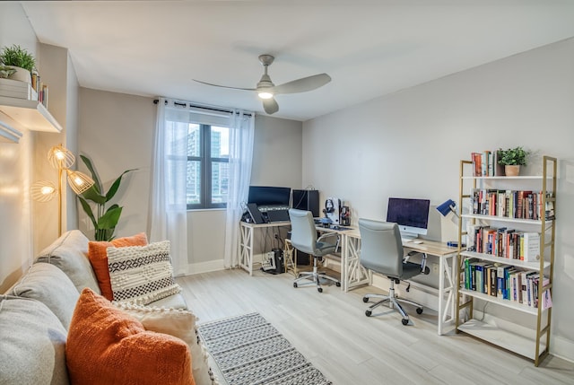 home office with ceiling fan and light hardwood / wood-style floors