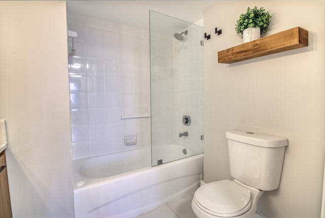 full bathroom featuring tile patterned floors, vanity, toilet, and tiled shower / bath combo