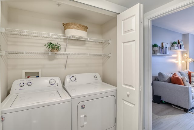 laundry area featuring washer and clothes dryer and hardwood / wood-style floors