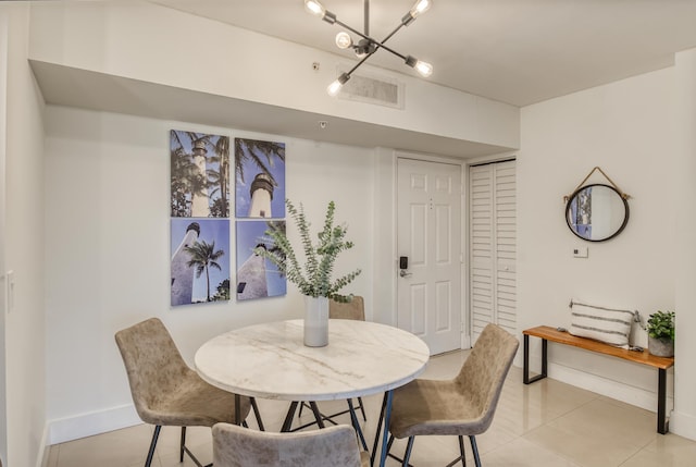 dining room with light tile patterned floors and a notable chandelier