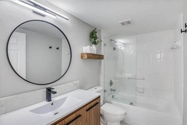 full bathroom featuring vanity, toilet, and bath / shower combo with glass door