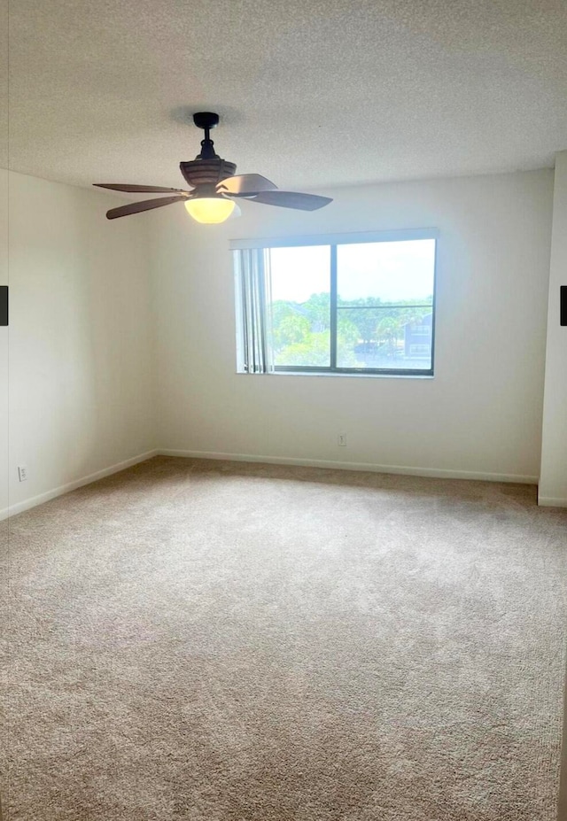 empty room featuring carpet, a textured ceiling, and ceiling fan