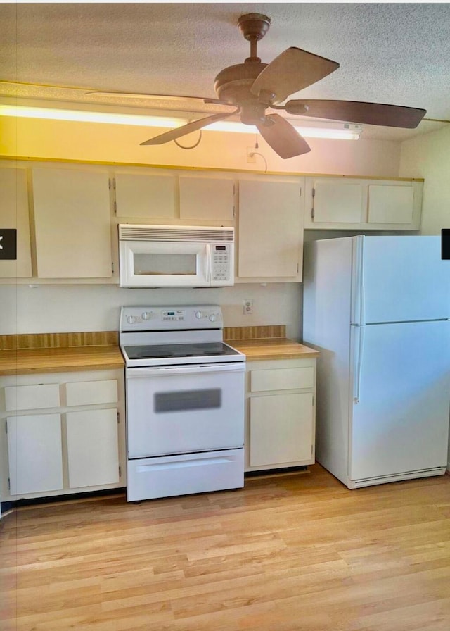 kitchen with white appliances, ceiling fan, a textured ceiling, light hardwood / wood-style floors, and butcher block counters