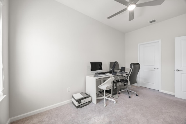 carpeted office featuring ceiling fan