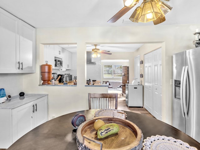 dining space with light hardwood / wood-style flooring