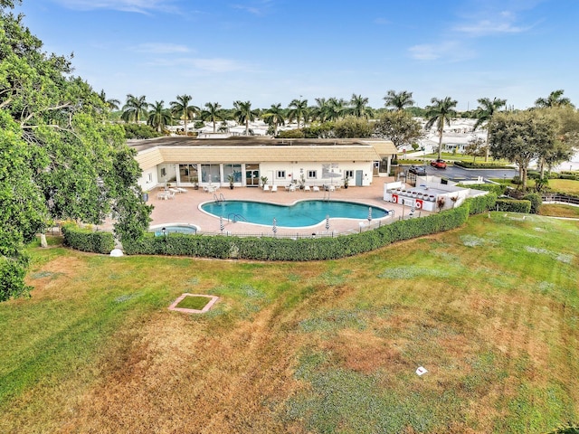 view of swimming pool with a lawn and a patio