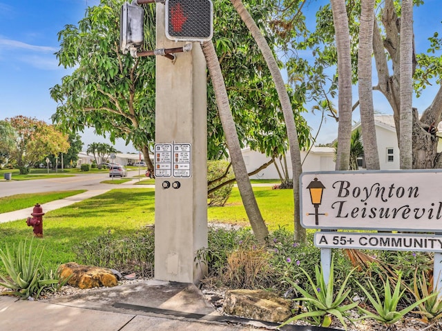 community / neighborhood sign with a lawn