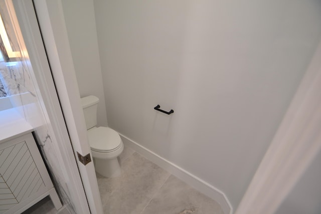 bathroom featuring tile patterned floors, vanity, and toilet