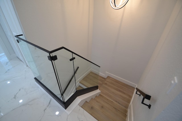 stairway with hardwood / wood-style floors