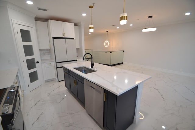 kitchen featuring white cabinets, appliances with stainless steel finishes, pendant lighting, and sink