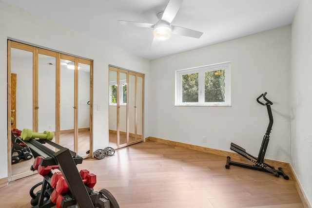 exercise room featuring ceiling fan, wood finished floors, and baseboards