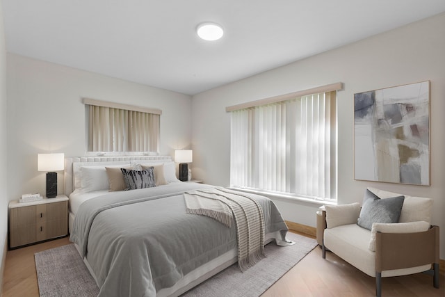 bedroom featuring baseboards and wood finished floors