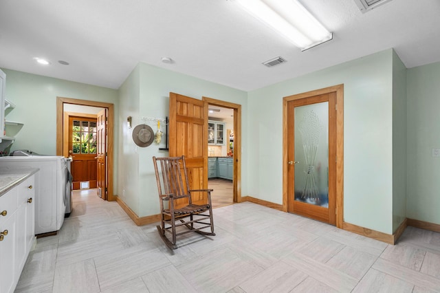 corridor featuring washer / dryer, visible vents, and baseboards