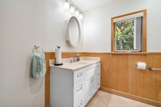 bathroom featuring tile patterned floors, vanity, and wood walls