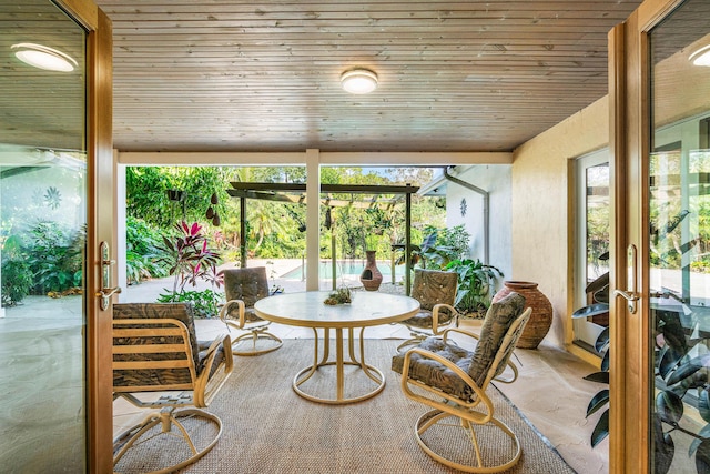 sunroom / solarium featuring wood ceiling and french doors