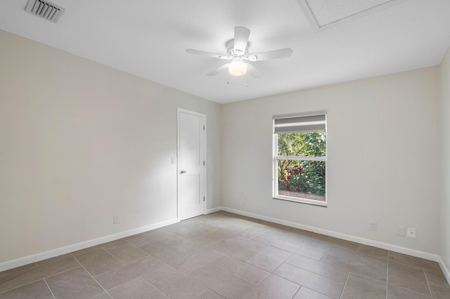 unfurnished room featuring a ceiling fan, visible vents, baseboards, and light tile patterned flooring