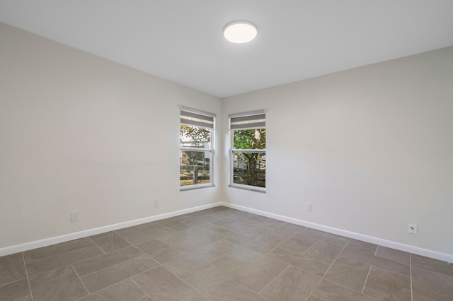 unfurnished room with tile patterned flooring