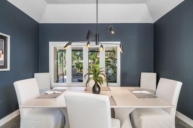 dining room featuring a textured ceiling and lofted ceiling